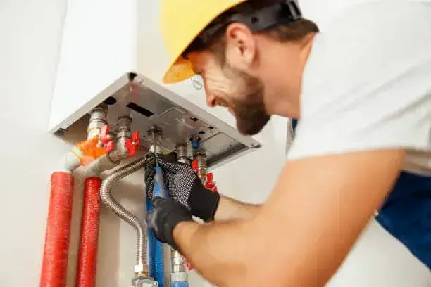 Technician reviewing electrical connections for a tankless water heater in Scott Depot, WV.