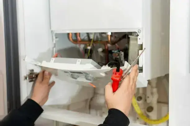 NexAir Home Services technician inspecting tankless water heater connections in Fraziers Bottom, WV. Tankless Water Heater Installation Near Me.