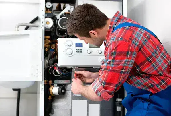 NexAir Home Services technician performing an operational check on a tankless water heater in Eleanor, WV. Tankless Water Heater Installation Near Me.