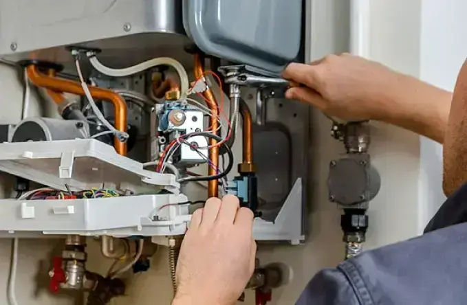 Homeowner discussing a tankless water heater upgrade with a technician in Point Pleasant, WV.