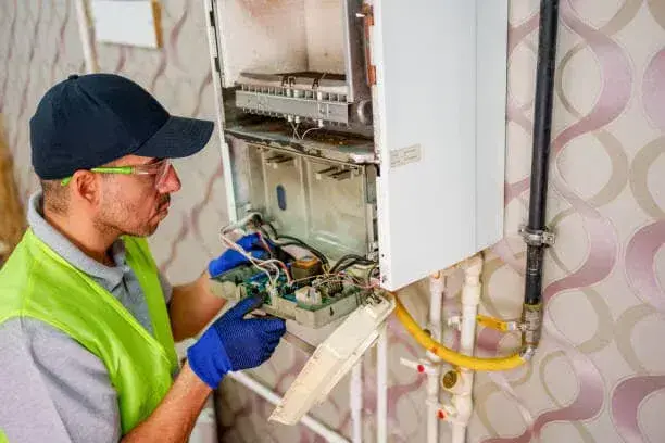 Technician reviewing venting connections for a tankless water heater in Hurricane, WV.